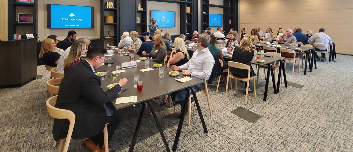 Attendees at a Biltmore Area Partnership luncheon meeting in Phoenix listening to a guest speaker at the Esplanade conference room